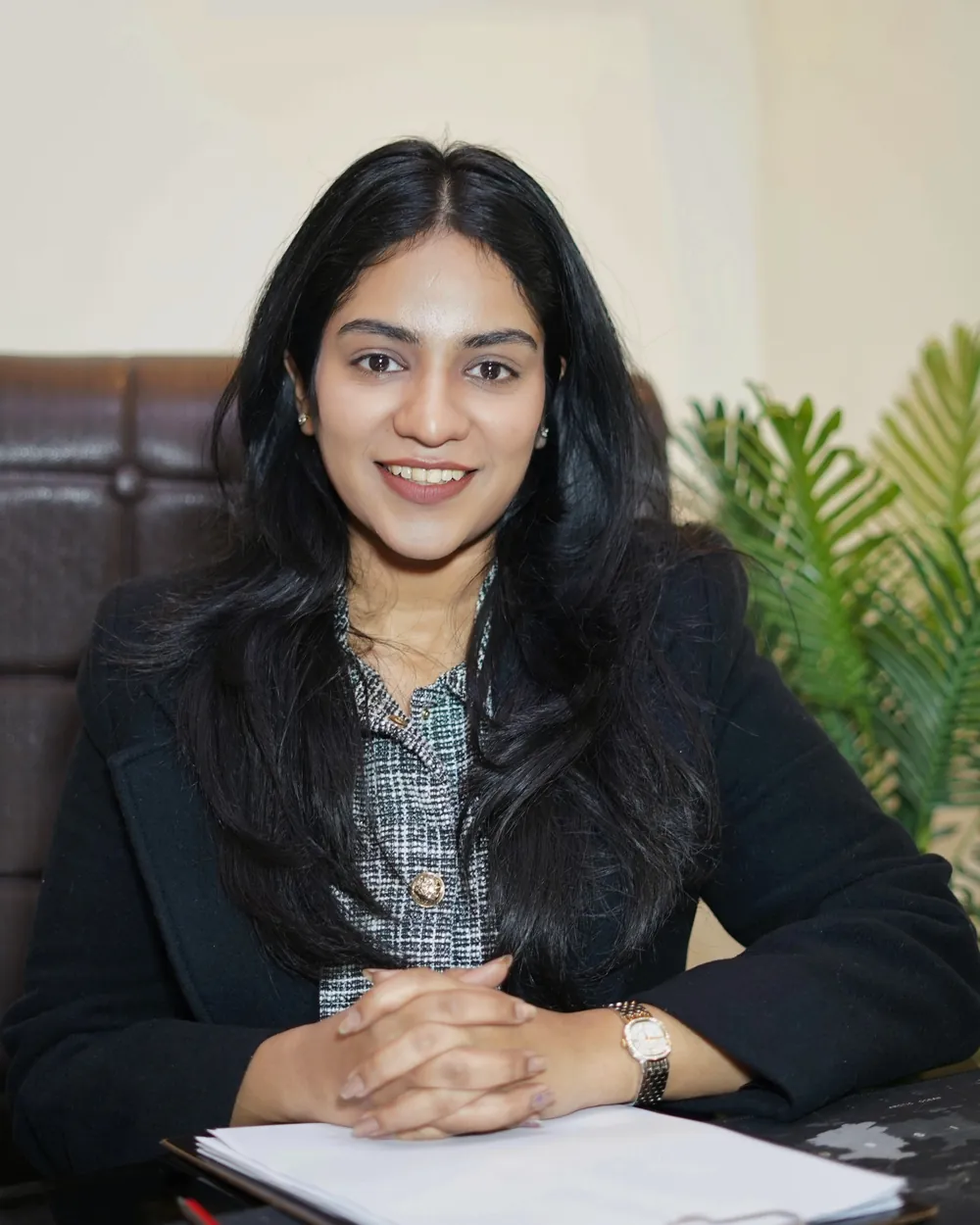 Dr. Kashish Singhal at her desk in the clinic, smiling